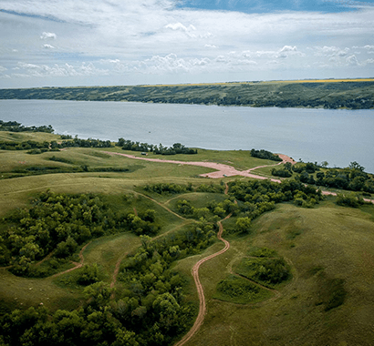 Grassy hillsides overlooking wide water views and lakefront lots.
